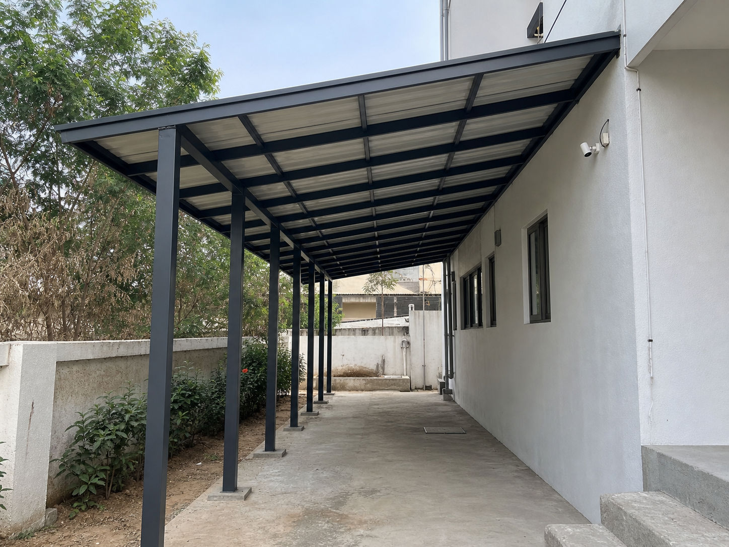 Custom steel covered walkway shed with fabricated columns and roof panels